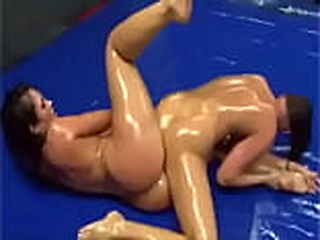 Three teen brunettes indulge in a sensual lesbian oil wrestling match.